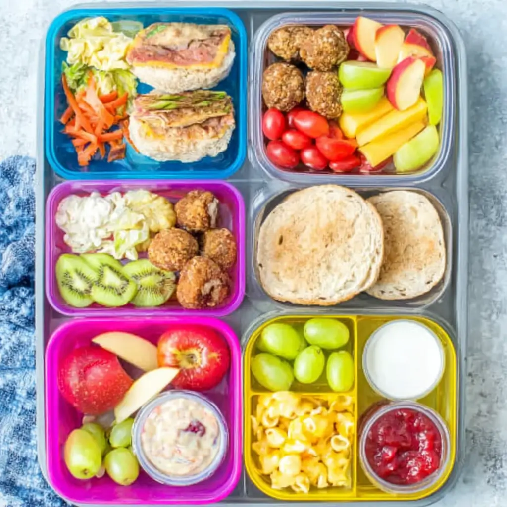 Healthy school lunch ideas for kids displayed in colorful lunch boxes